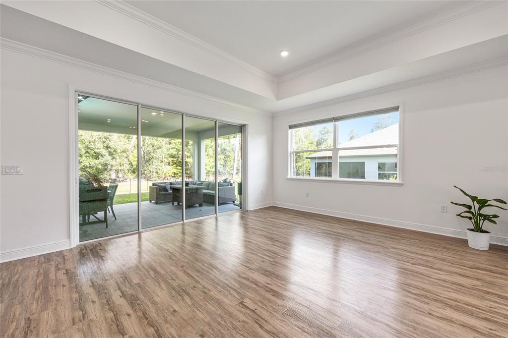 69 Grass Street Homosassa, FL 34446 - Photo 20 of 72 a view of an empty room with wooden floor and a window