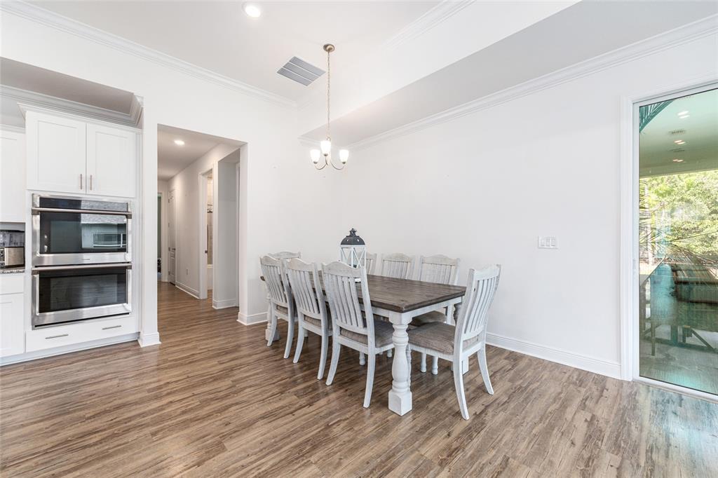 69 Grass Street Homosassa, FL 34446 - Photo 23 of 72 a view of a dining room with furniture and wooden floor