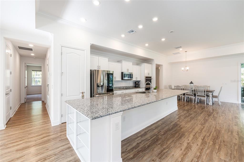 69 Grass Street Homosassa, FL 34446 - Photo 25 of 72 a large kitchen with kitchen island a sink table and chairs