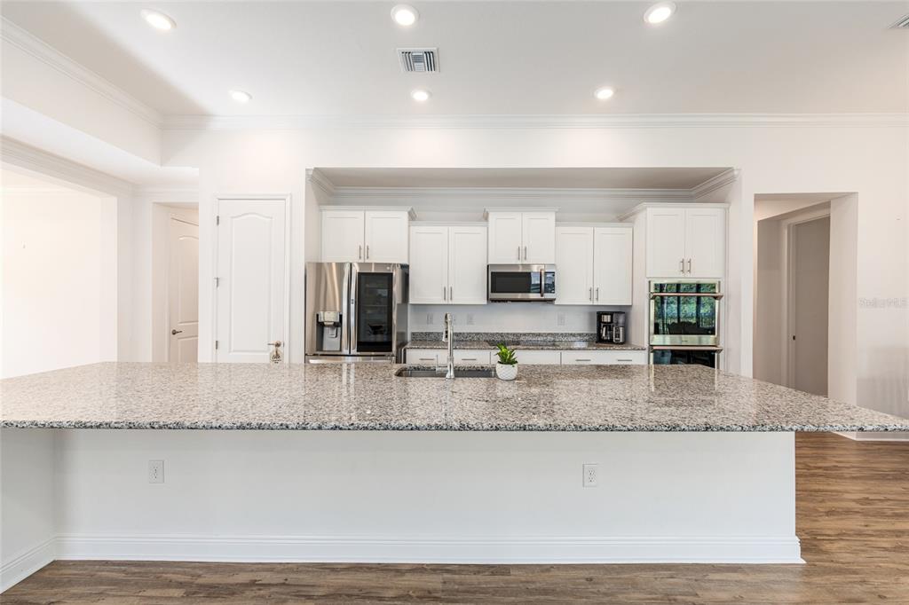 69 Grass Street Homosassa, FL 34446 - Photo 27 of 72 a large kitchen with granite countertop a large counter top and stainless steel appliances