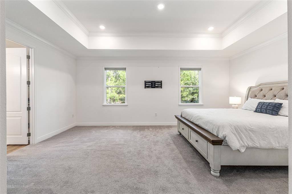 69 Grass Street Homosassa, FL 34446 - Photo 30 of 72 a spacious bedroom with a bed and a window