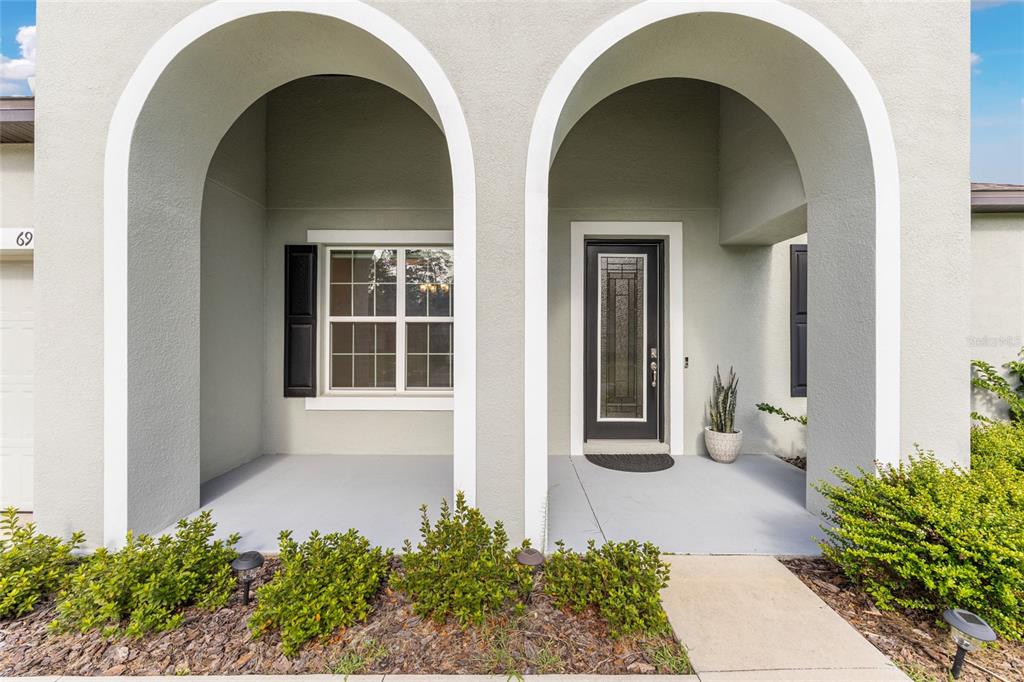 69 Grass Street Homosassa, FL 34446 - Photo 3 of 72 a front view of a house with a porch