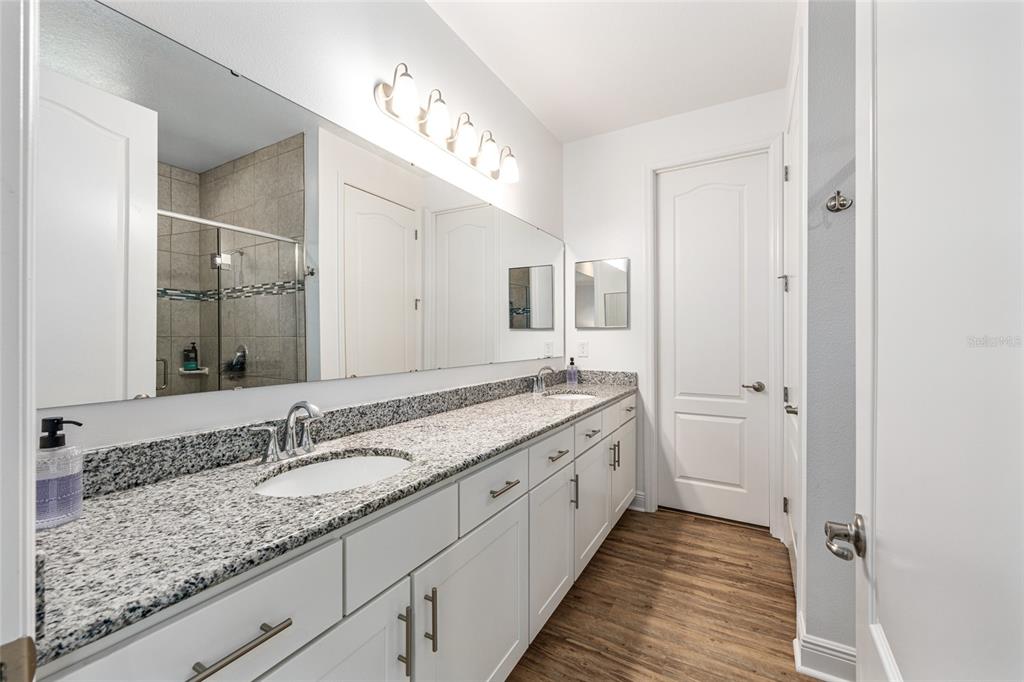 69 Grass Street Homosassa, FL 34446 - Photo 33 of 72 a bathroom with a granite countertop sink double and mirror