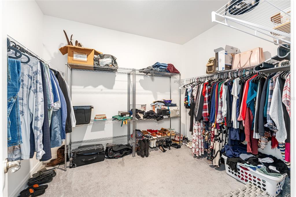 69 Grass Street Homosassa, FL 34446 - Photo 35 of 72 a view of walk in closet with clothes and shoes