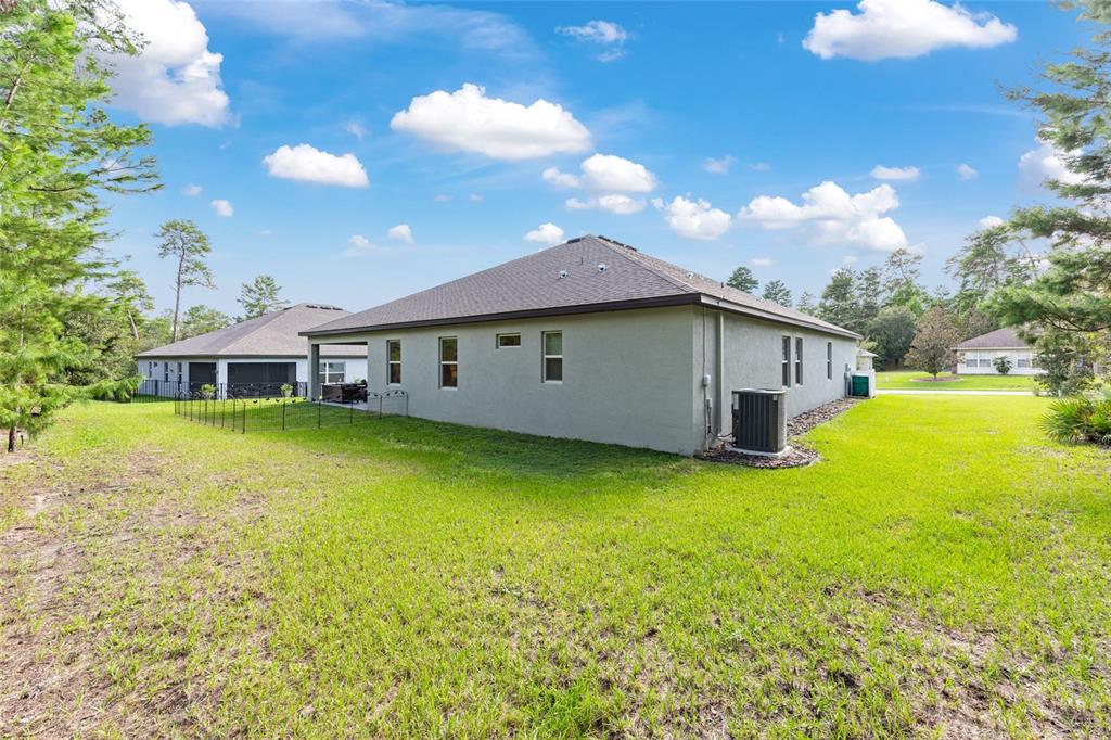 69 Grass Street Homosassa, FL 34446 - Photo 55 of 72 a front view of house with yard and swimming pool