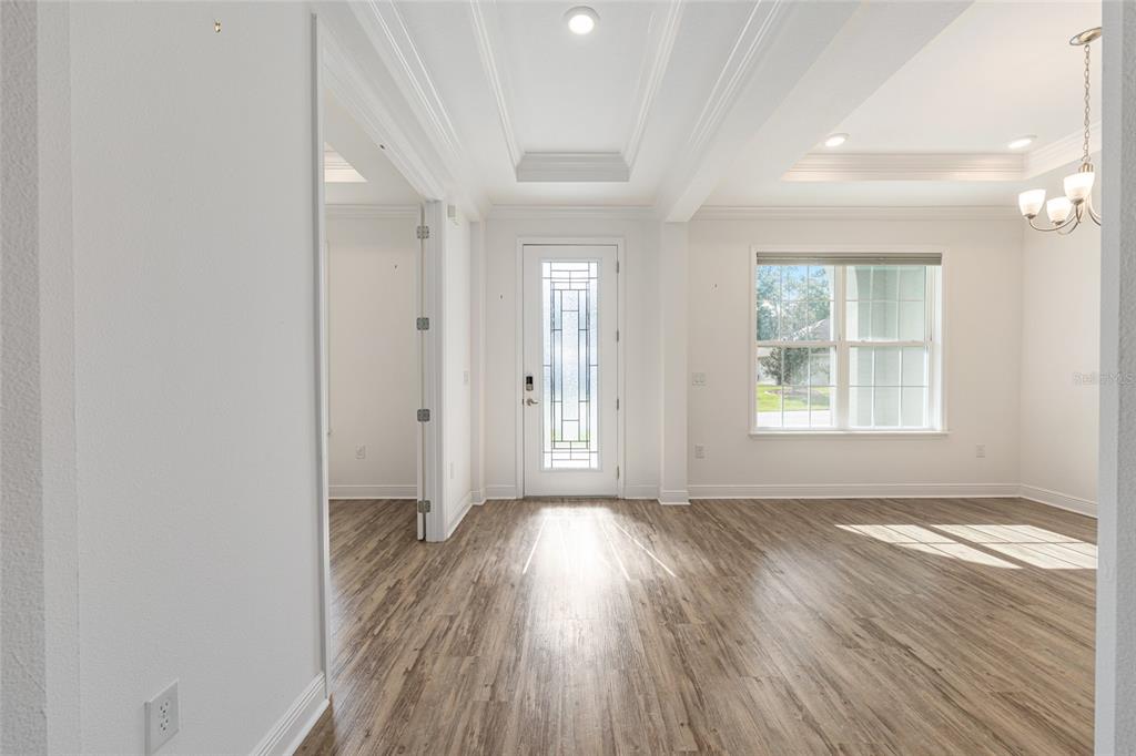 69 Grass Street Homosassa, FL 34446 - Photo 8 of 72 an empty room with wooden floor and windows