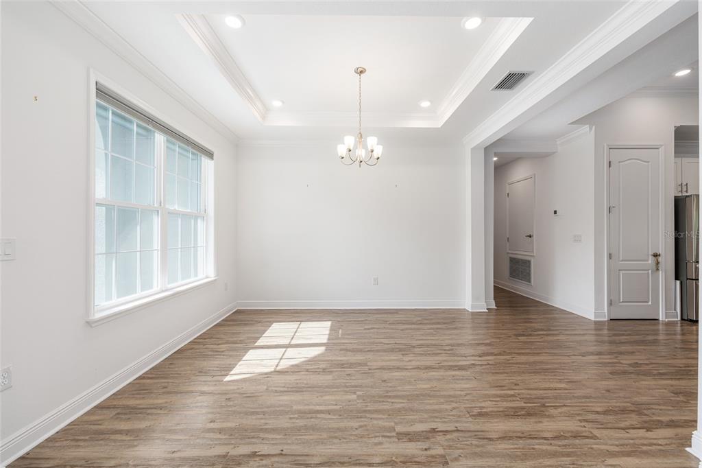 69 Grass Street Homosassa, FL 34446 - Photo 9 of 72 a view of empty room with wooden floor and fan