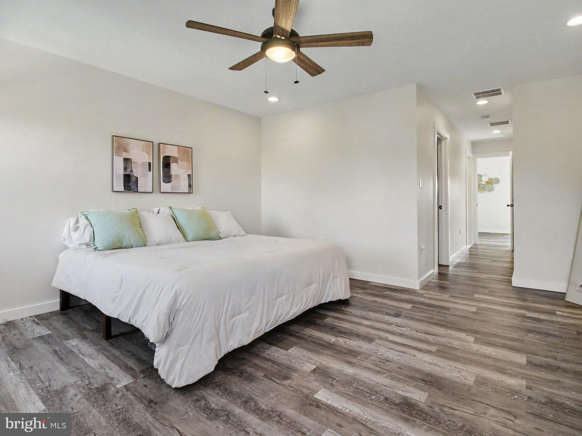 3915 Roland Avenue Baltimore, MD 21211 - Photo 15 of 26 a bedroom with a bed and a chandelier