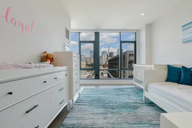 a living room with furniture and large window