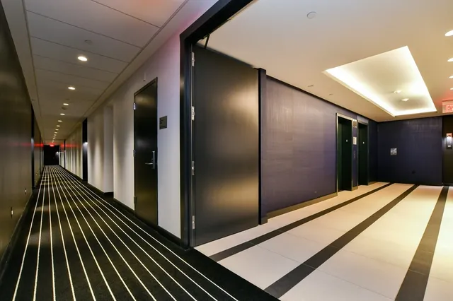 a view of gallery with wooden floor