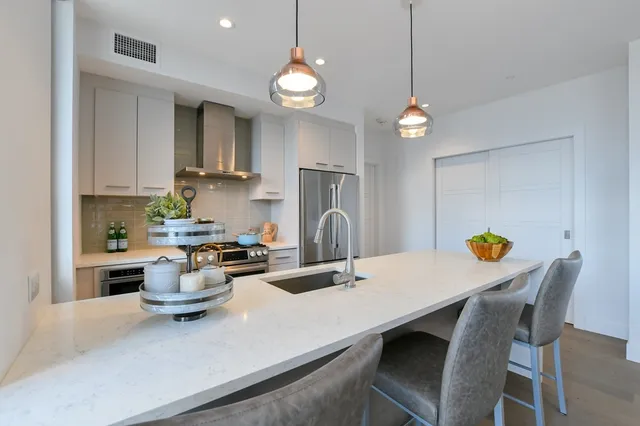 a kitchen with a dining table and chairs