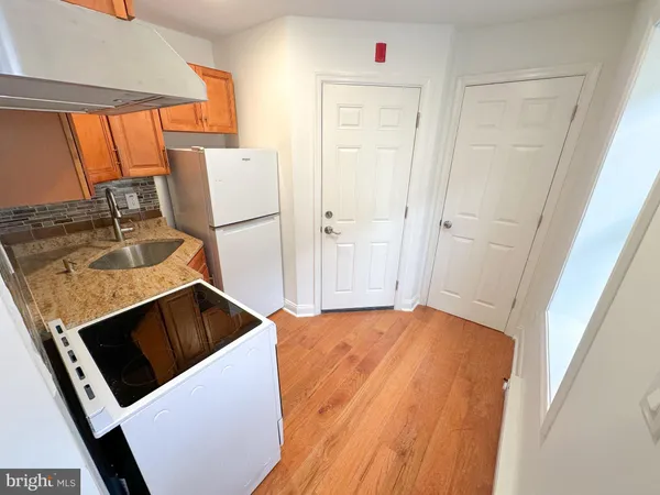 a kitchen with a sink and a refrigerator