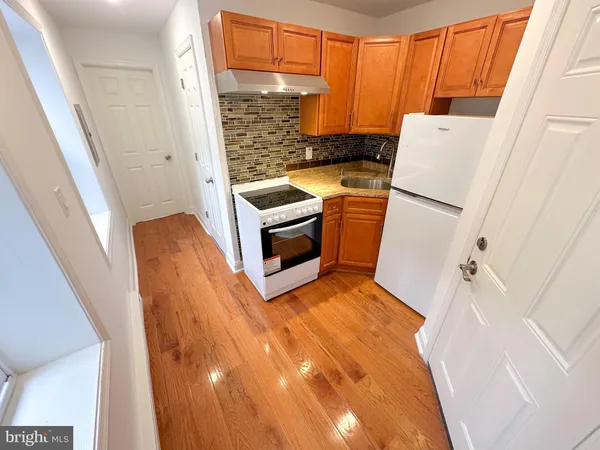 a kitchen with a refrigerator a stove a washer and dryer
