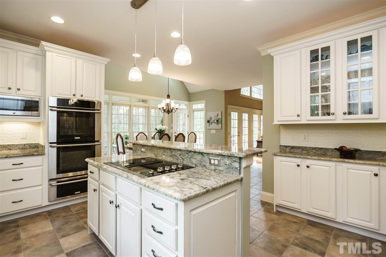 12432 Bayleaf Church Road Raleigh, NC 27614 - Photo 11 of 25 a kitchen with granite countertop a sink stove and refrigerator