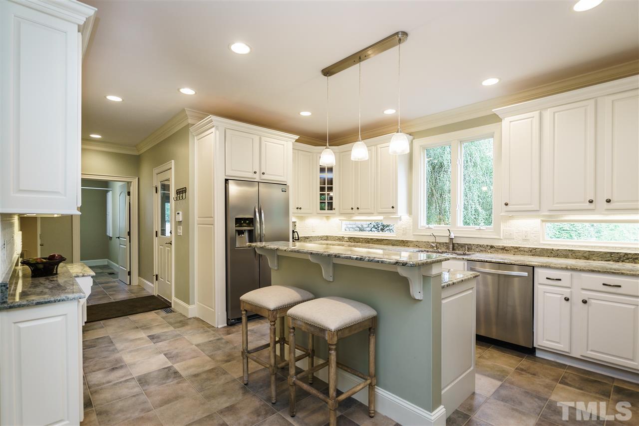 12432 Bayleaf Church Road Raleigh, NC 27614 - Photo 12 of 25 a kitchen with a sink stove and refrigerator