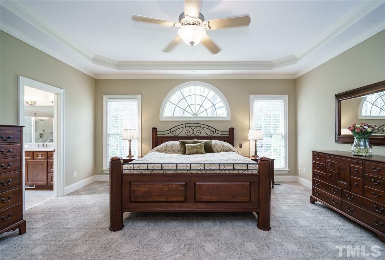 12432 Bayleaf Church Road Raleigh, NC 27614 - Photo 13 of 25 a spacious bedroom with a bed and a dresser in it