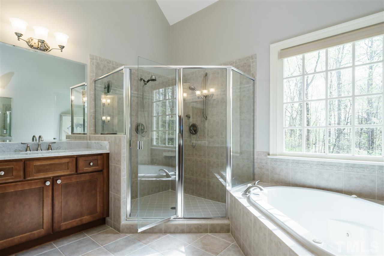 12432 Bayleaf Church Road Raleigh, NC 27614 - Photo 14 of 25 a bathroom with a bathtub shower and sink