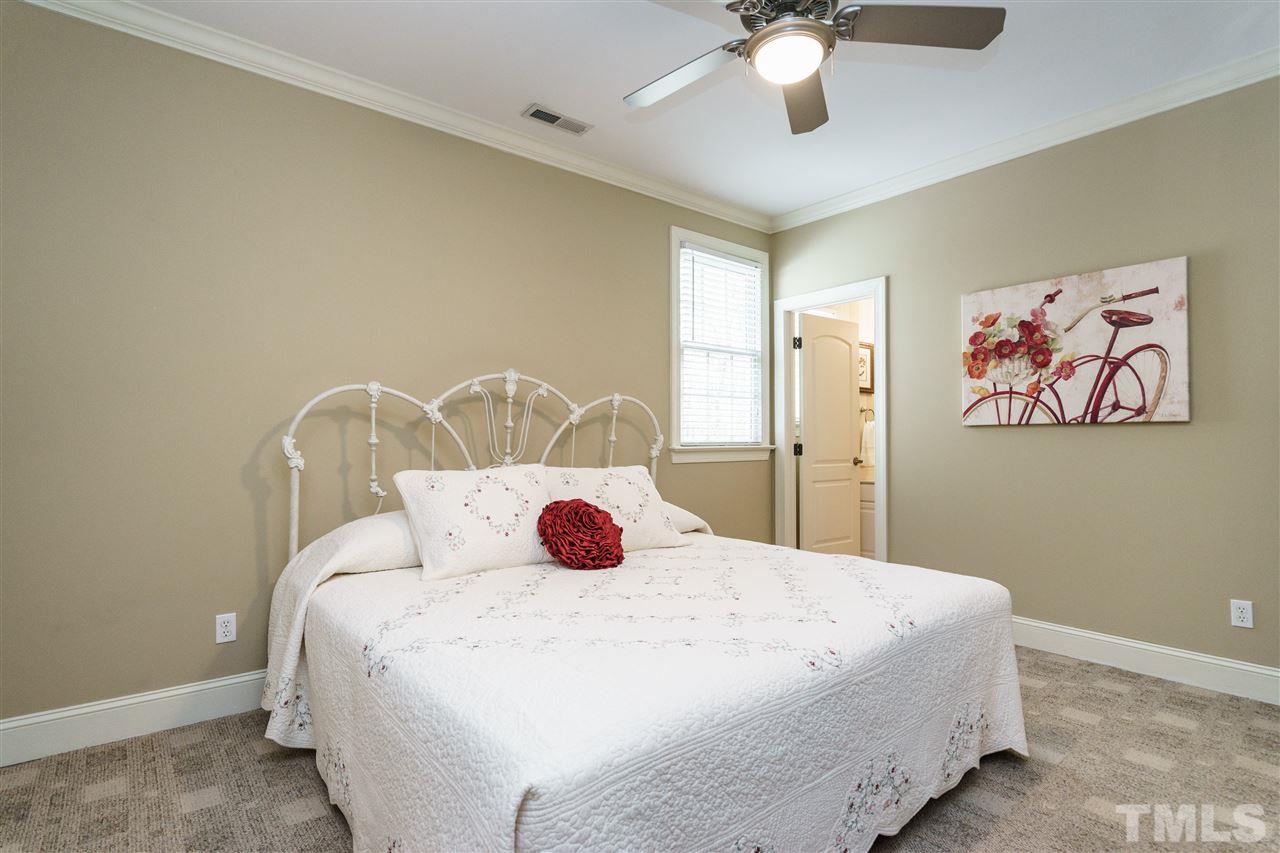 12432 Bayleaf Church Road Raleigh, NC 27614 - Photo 15 of 25 a bedroom with a bed and a chandelier