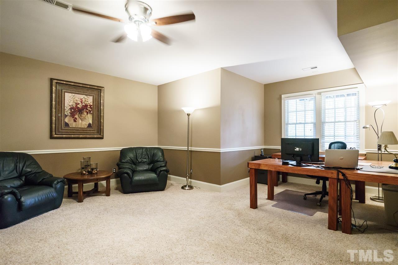 12432 Bayleaf Church Road Raleigh, NC 27614 - Photo 17 of 25 a work room with furniture a bookshelf and a window