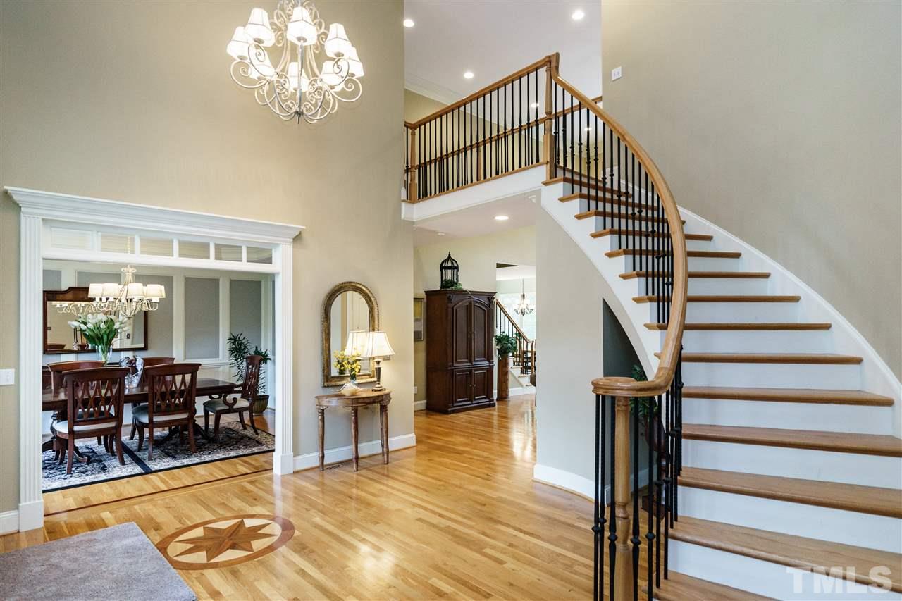 12432 Bayleaf Church Road Raleigh, NC 27614 - Photo 3 of 25 a view of a livingroom with furniture staircase and kitchen view