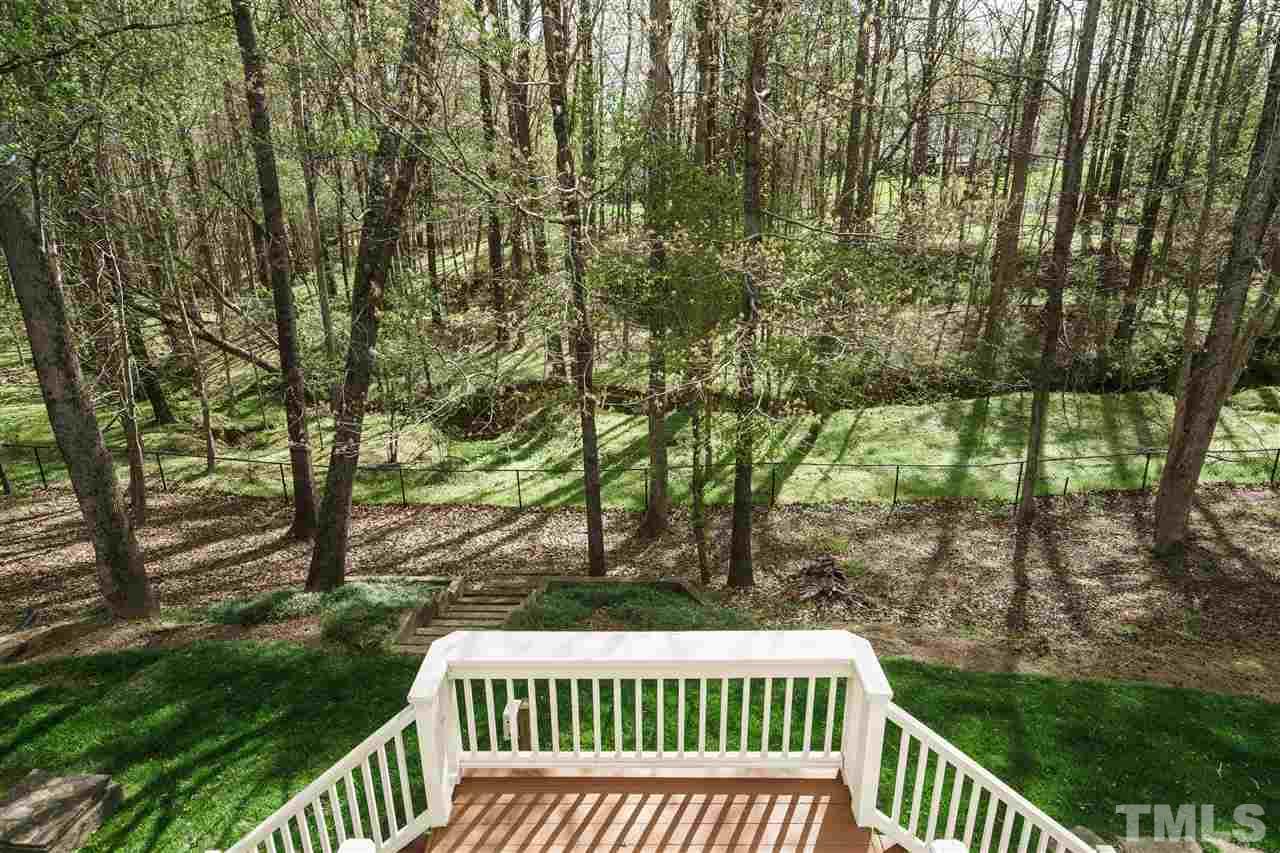 12432 Bayleaf Church Road Raleigh, NC 27614 - Photo 22 of 25 a view of a roof deck with table and chairs and wooden fence