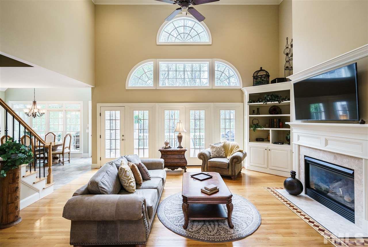 12432 Bayleaf Church Road Raleigh, NC 27614 - Photo 7 of 25 a living room with furniture a fireplace and a flat screen tv