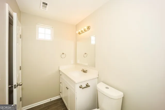 a white toilet sitting next to a bathroom sink
