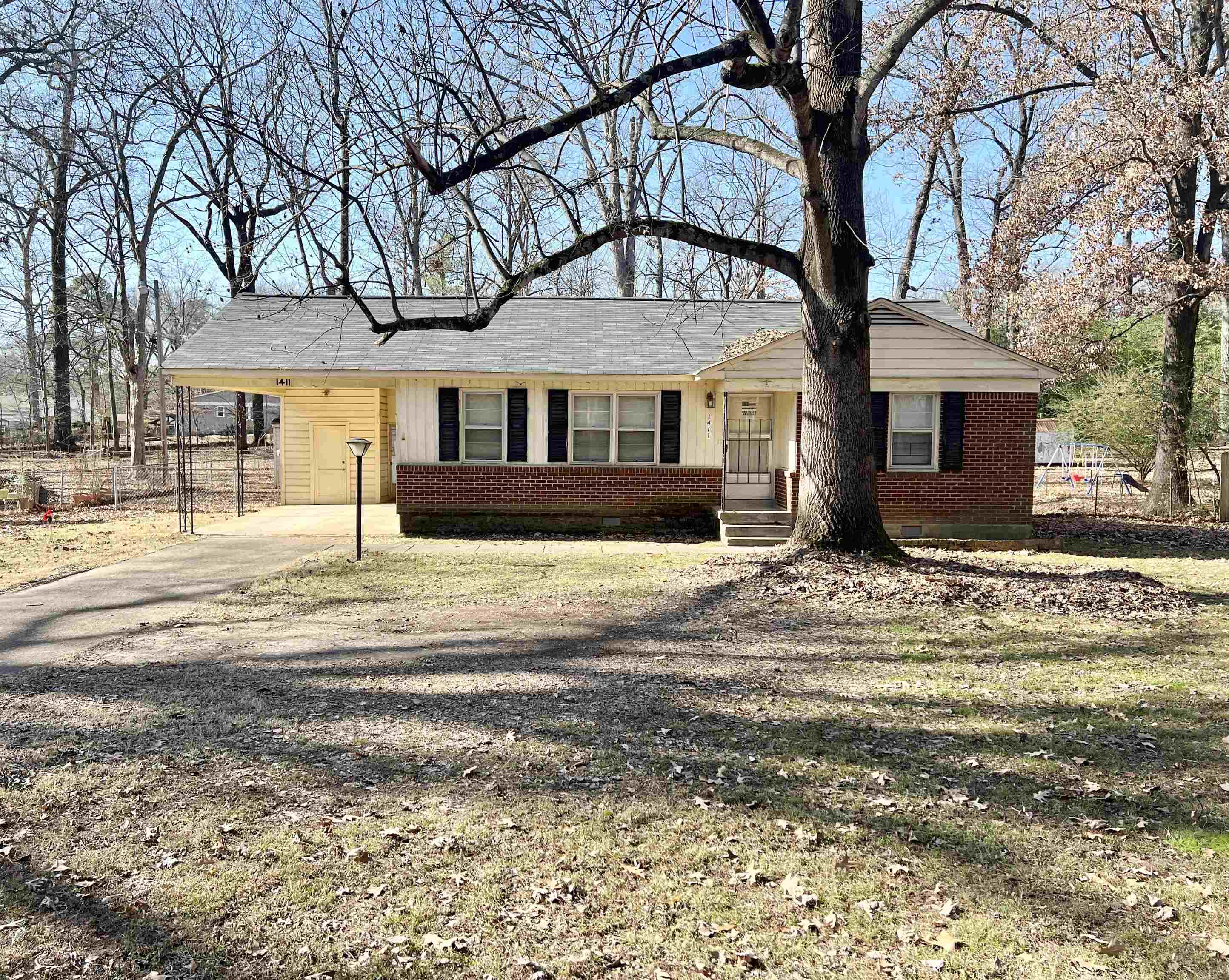 1411 Whitten Road Memphis, TN 38134 - Photo 1 of 9 a front view of a house with a yard