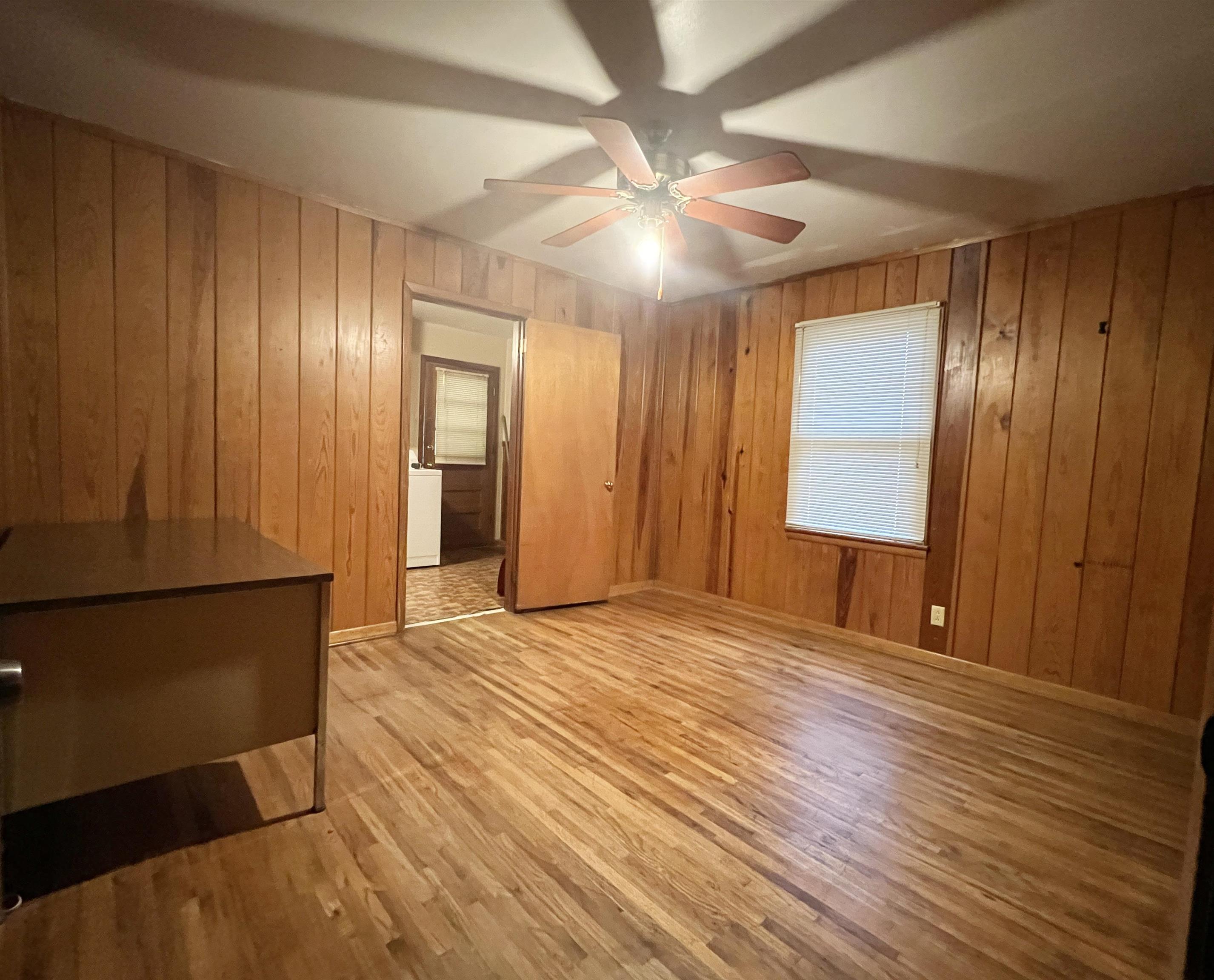 1411 Whitten Road Memphis, TN 38134 - Photo 8 of 9 a view of an empty room with window and wooden floor