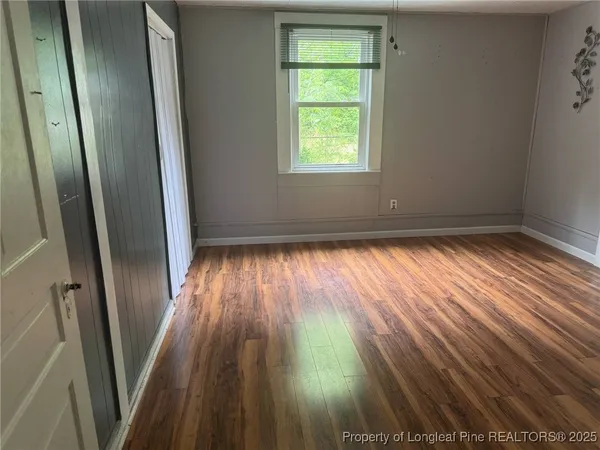 wooden floor in an empty room with a fireplace