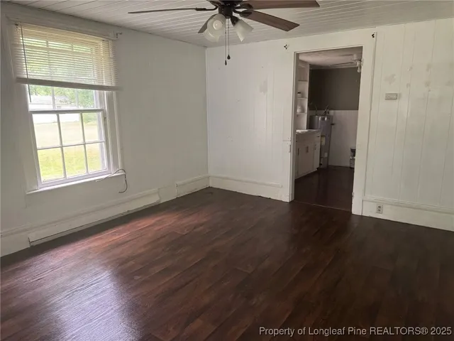 a view of a kitchen with refrigerator and window