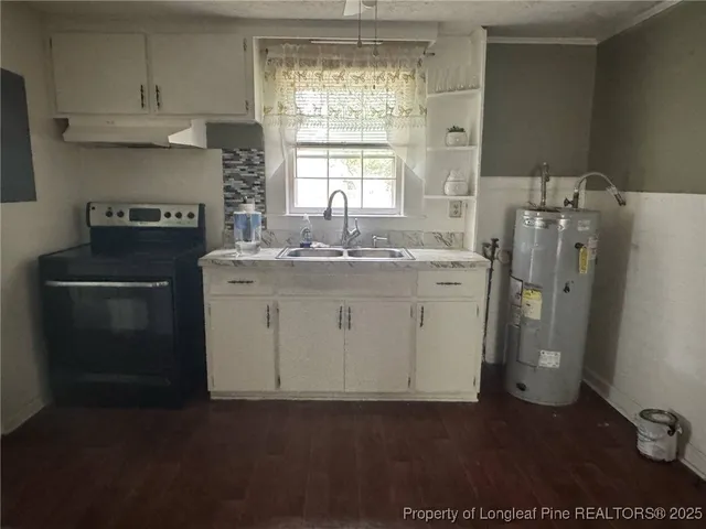 a kitchen with a refrigerator and a stove