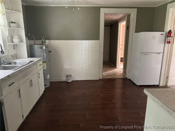 a view of a kitchen with wooden floor