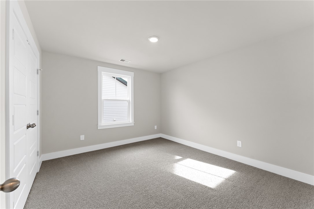 167 Tiger Lily Drive Anderson, SC 29621 - Photo 20 of 34 A well-lit room awaits, offering soft carpet and a clean palette for personalization.