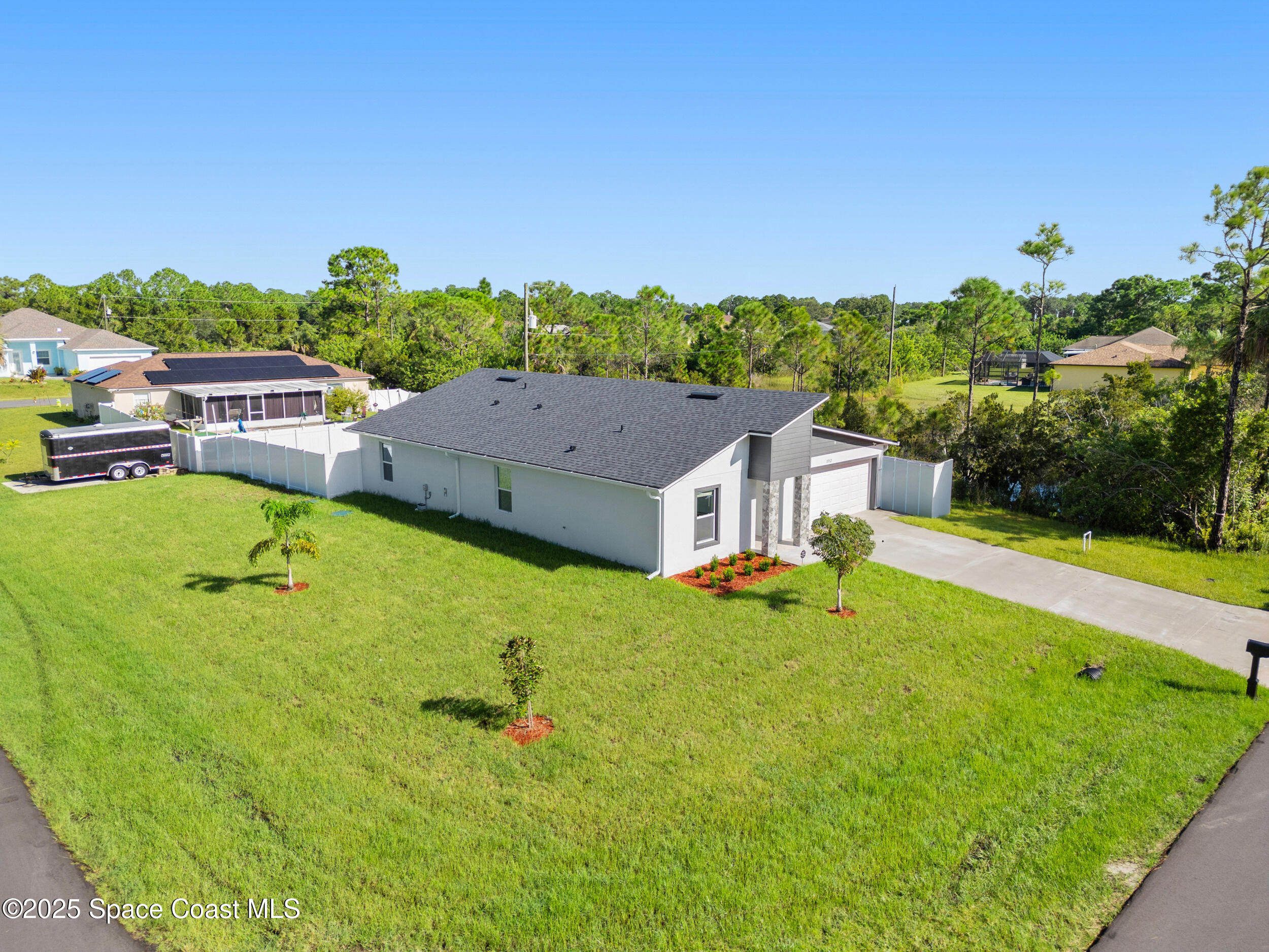 an aerial view of a house with swimming pool garden and mountain view in back