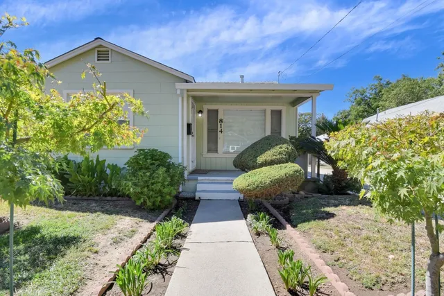 a front view of a house with garden
