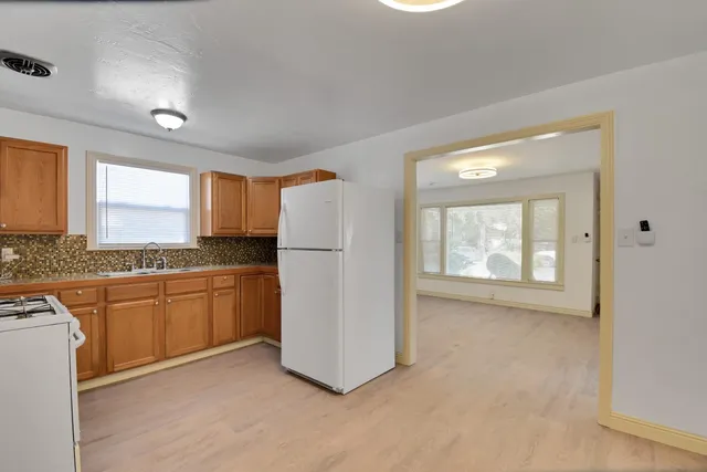 a view of a kitchen with a sink cabinet and a window