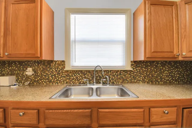 a bathroom with a sink a vanity and a window