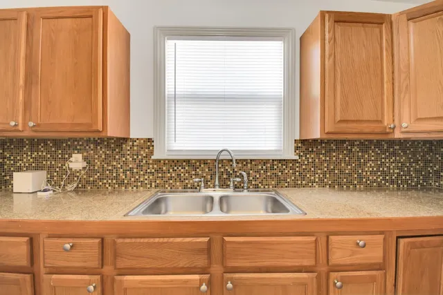 a kitchen with a sink and cabinets