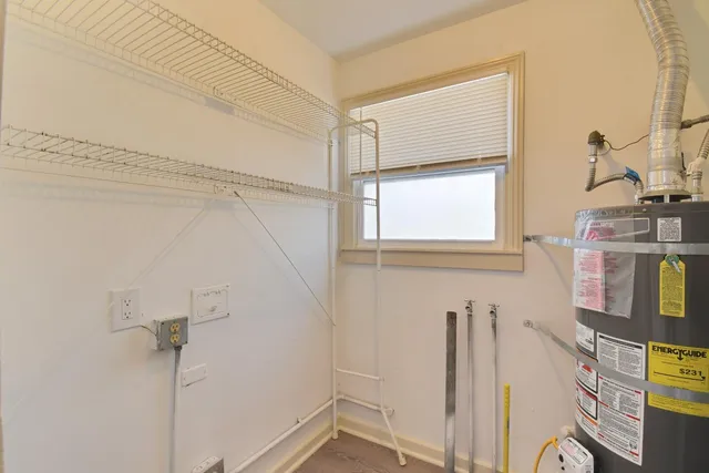 a view of a hallway with wooden floor and closet