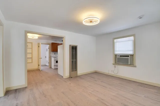 a view of empty room with wooden floor