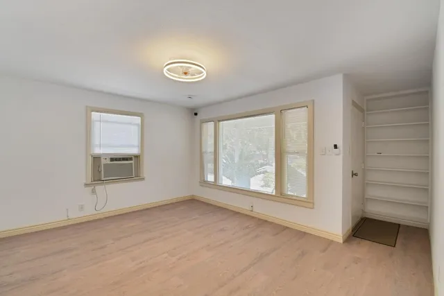 an empty room with a empty space and windows