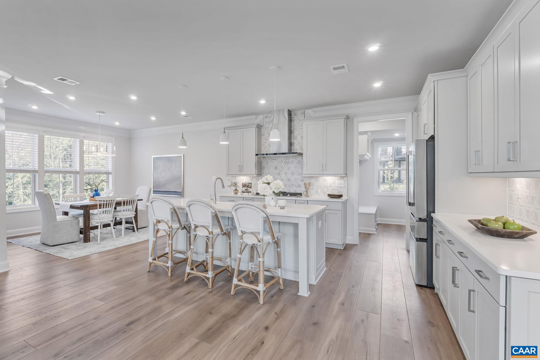 1805 Fowler Street Charlottesville, VA 22901 - Photo 15 of 60 a kitchen with white cabinets and chairs