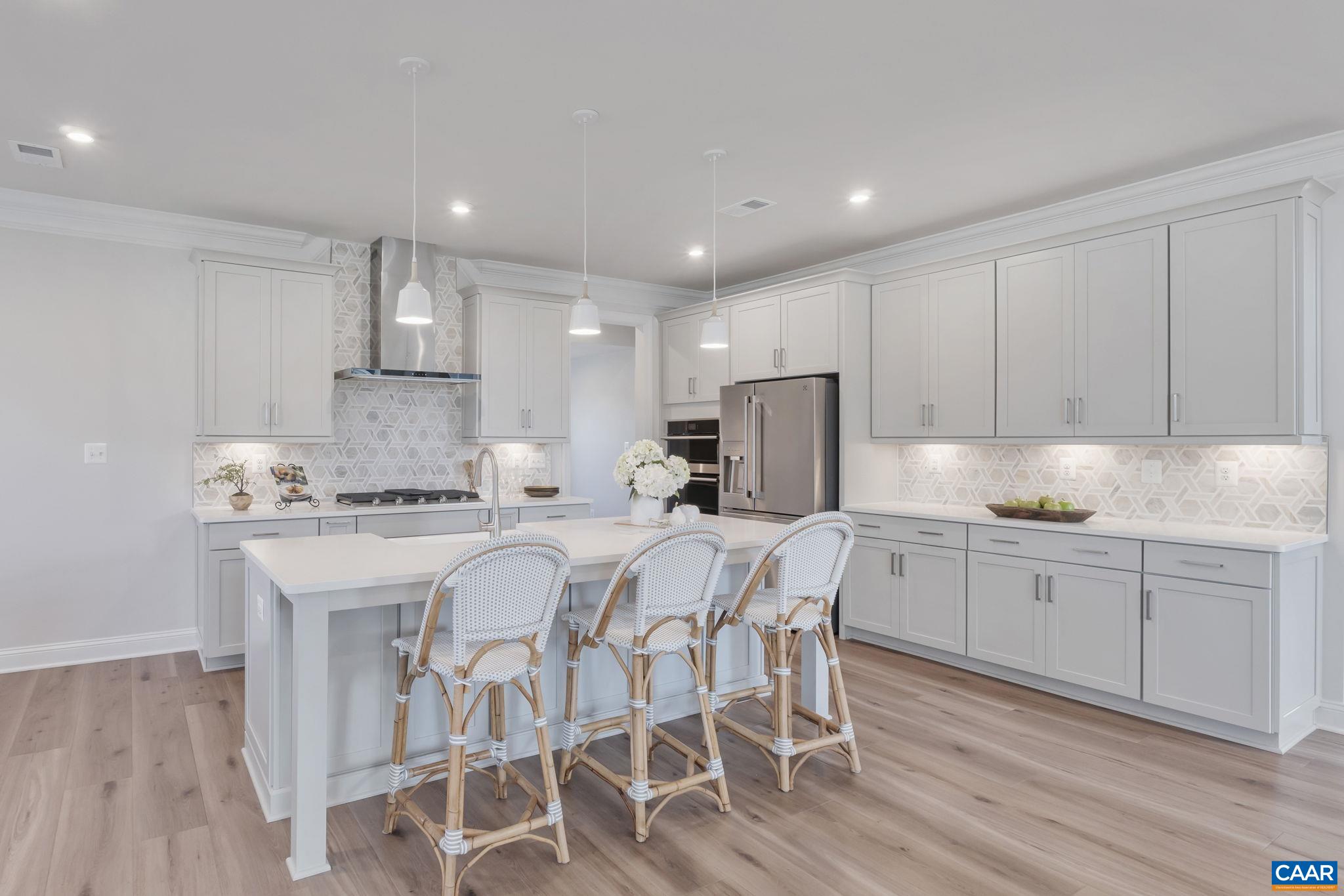 1805 Fowler Street Charlottesville, VA 22901 - Photo 16 of 60 a kitchen with stainless steel appliances granite countertop a white cabinets and wooden floor