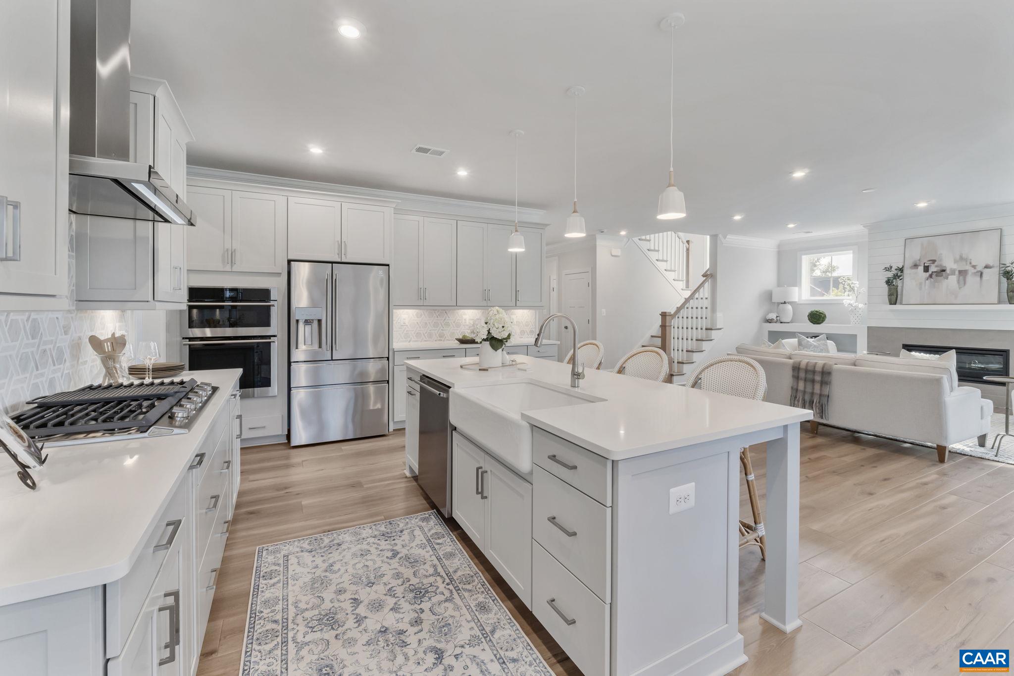 1805 Fowler Street Charlottesville, VA 22901 - Photo 17 of 60 a kitchen with white cabinets and stainless steel appliances