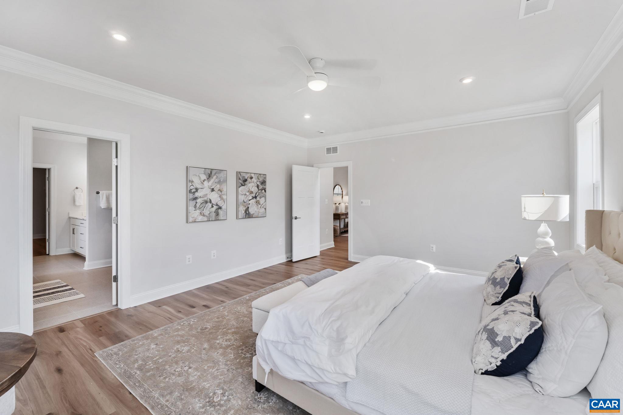 1805 Fowler Street Charlottesville, VA 22901 - Photo 34 of 60 a bedroom with a large bed and a chandelier