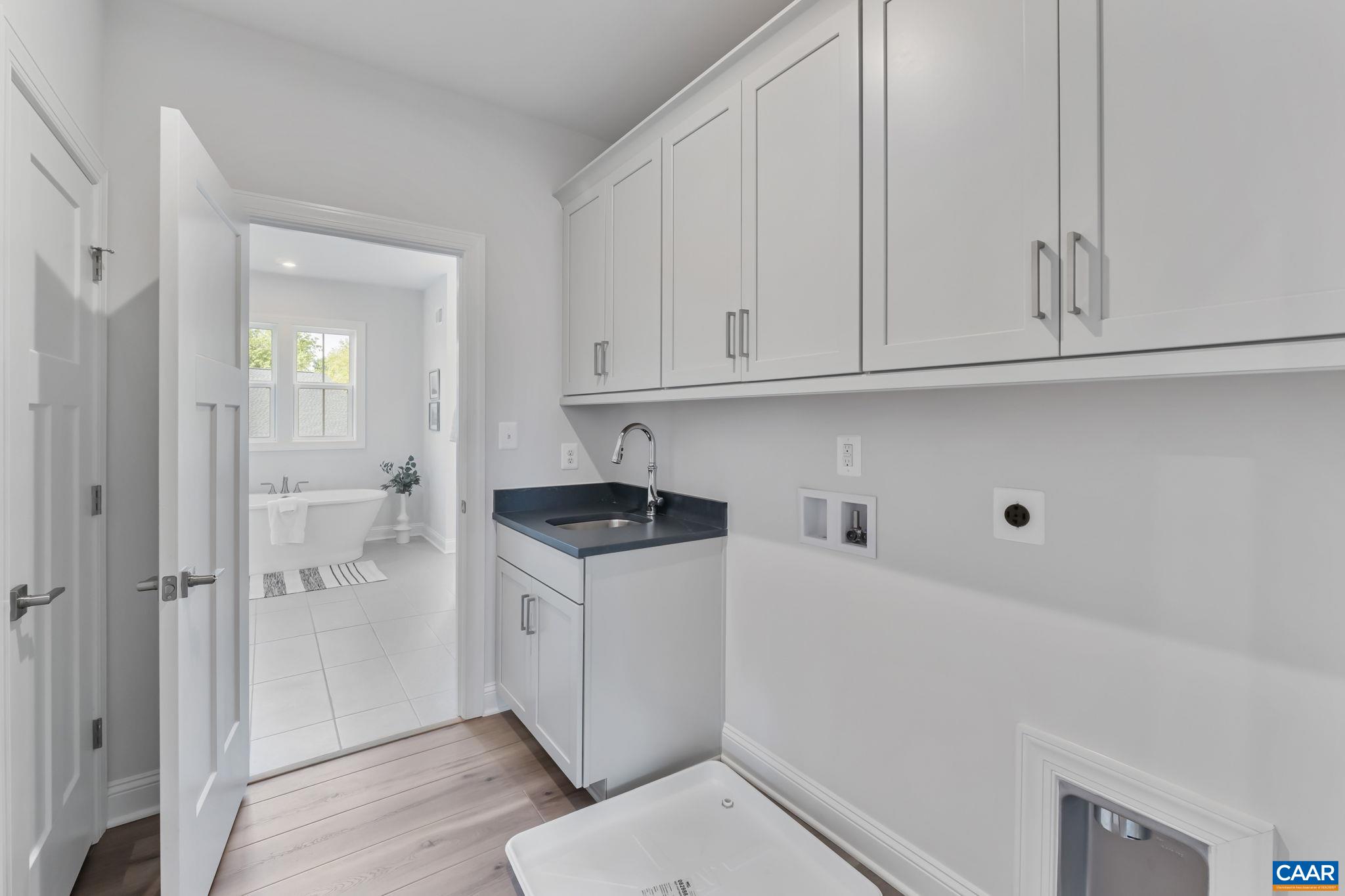 1805 Fowler Street Charlottesville, VA 22901 - Photo 41 of 60 a kitchen with white cabinets and white appliances