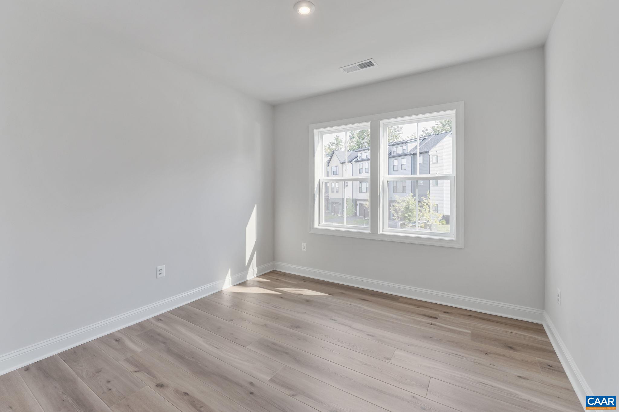 1805 Fowler Street Charlottesville, VA 22901 - Photo 48 of 60 an empty room with wooden floor and windows