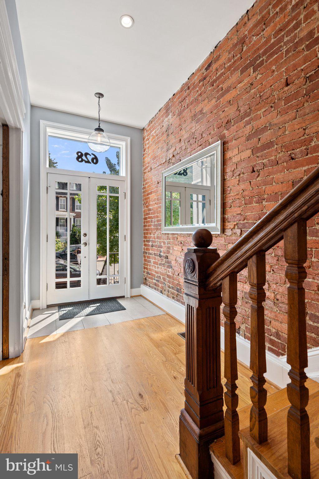 628 E Street Northeast Washington, DC 20002 - Photo 3 of 46 French entry doors and exposed brick wall