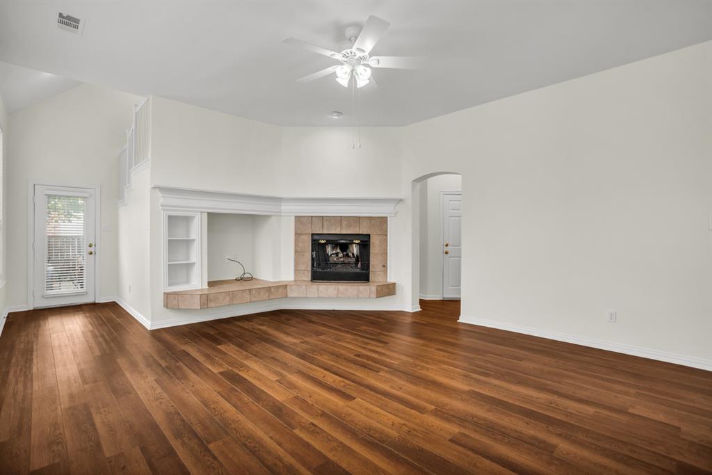 1610 Mapleleaf Falls Drive Allen, TX 75002 - Photo 16 of 36 a view of an empty room with wooden floor and a window